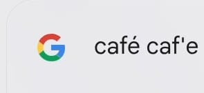 The launcher search box showing café typed on the International layout followed by caf'e typed on the US layout