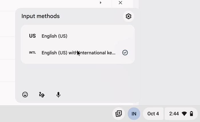 The shelf Input methods menu with US English (US) and INTL English (US) with International keyboard, the international row checked, and the shelf label showing IN