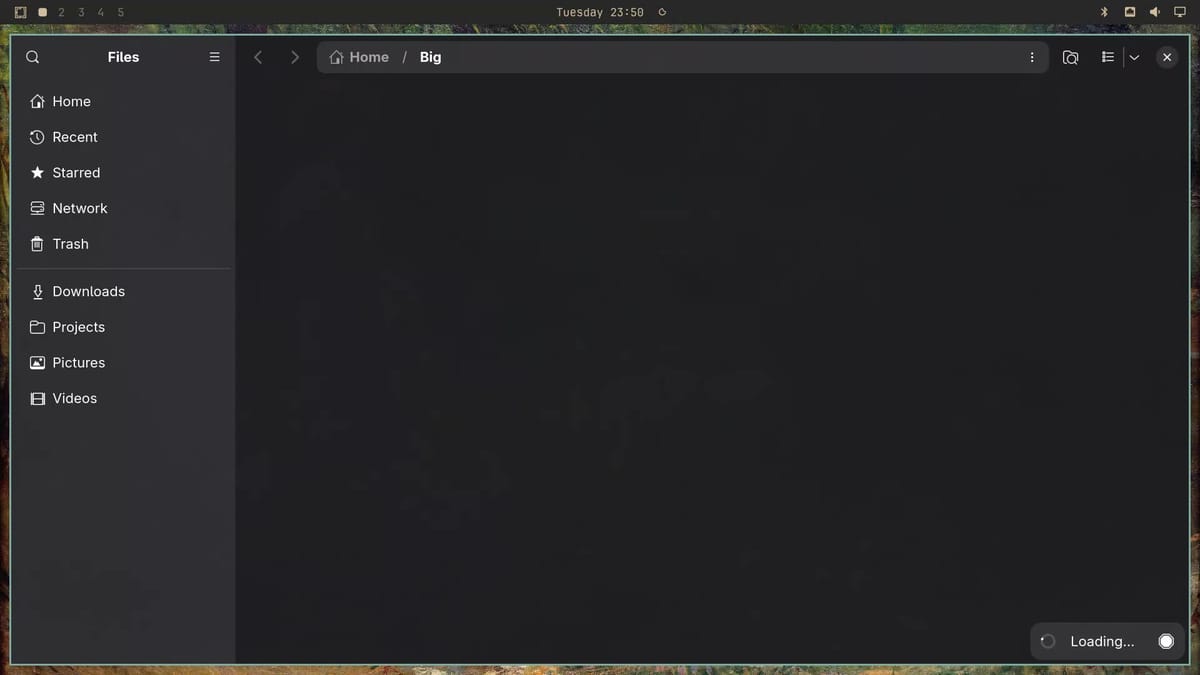 Nautilus open on the Big folder with an empty window and a Loading indicator in the bottom corner, before any icons appear