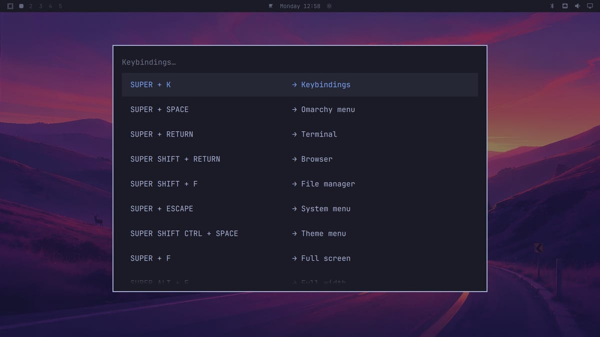 The Omarchy Keybindings list open over the desktop, starting with SUPER + K Keybindings, SUPER + SPACE Omarchy menu, SUPER + RETURN Terminal, and SUPER SHIFT + RETURN Browser