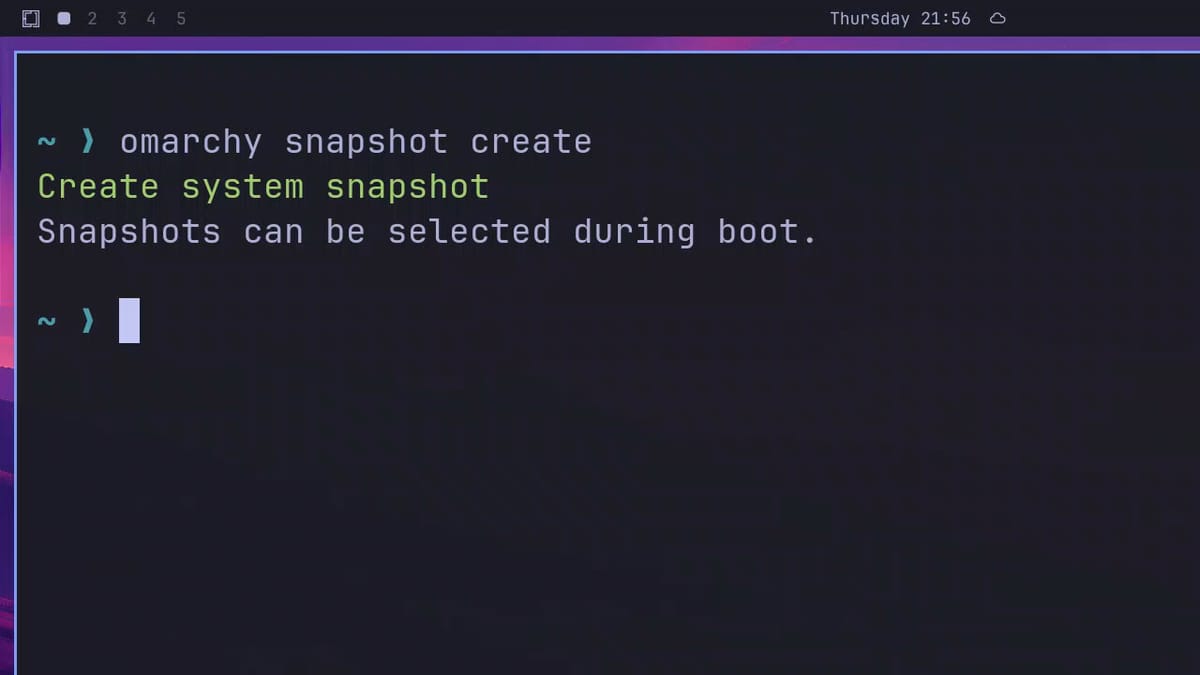 A terminal after omarchy snapshot create, showing Create system snapshot in green and Snapshots can be selected during boot below it
