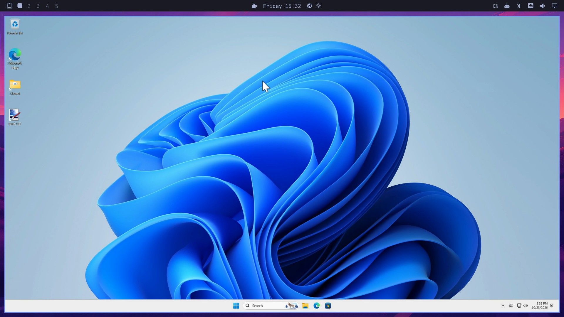 The Windows 11 desktop in a tiled Omarchy window below the Omarchy top bar, with Recycle Bin, Microsoft Edge, Shared, and Paint.NET icons and the Windows taskbar at the bottom