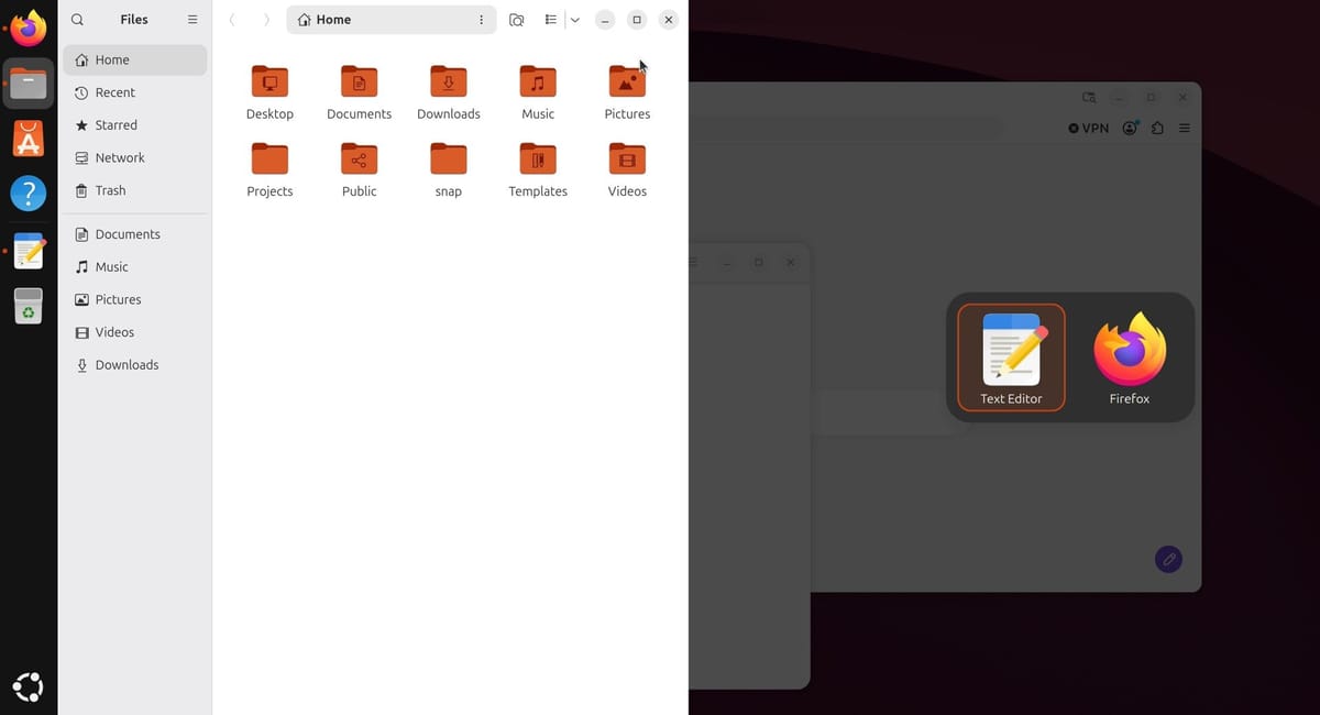 Files snapped to the left half of the screen, with a box on the dimmed right half offering Text Editor and Firefox to fill the space