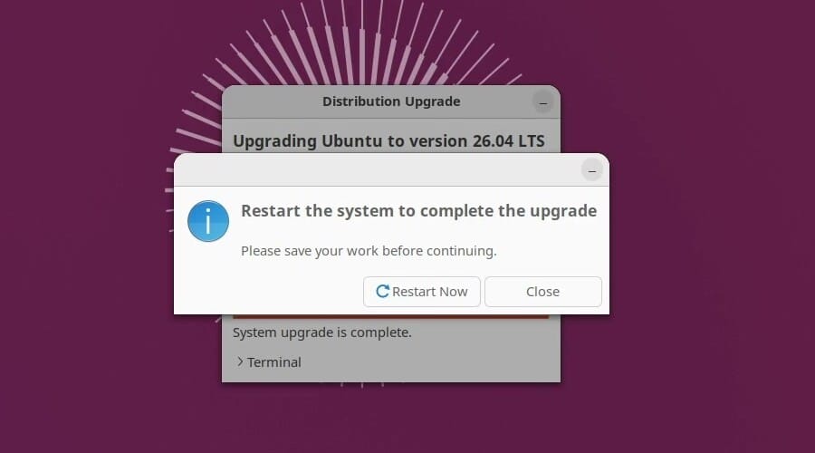 The upgrader's final dialog, Restart the system to complete the upgrade, with Restart Now and Close buttons over the Distribution Upgrade window