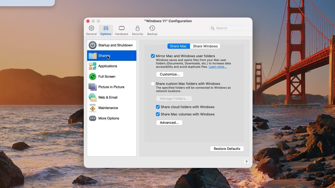 Parallels Desktop Configuration, Options tab, Sharing pane, with Mirror Mac and Windows user folders, Share cloud folders, and Share Mac volumes ticked by default